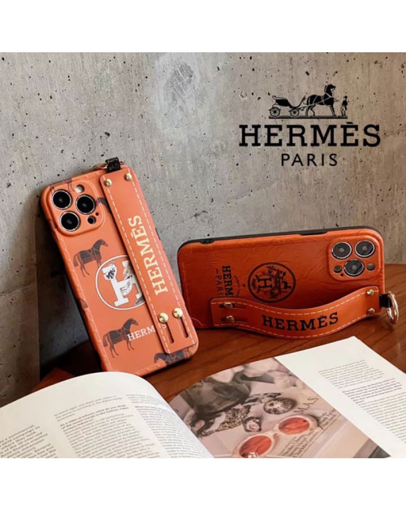 エルメス iphone16 pro/15 pro maxケースハンドベルト付きアイフォン15 proケースHERMES iphone14 pro max保護ケースお洒落人気アイフォン13 proケースオレンジ高級感