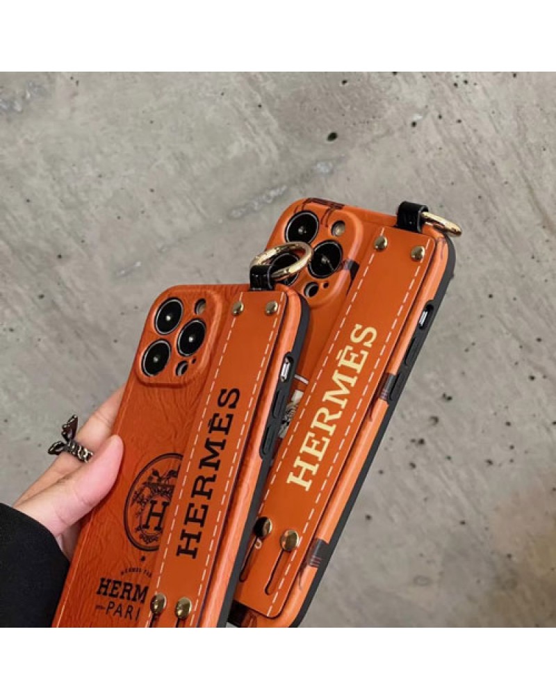 エルメス iphone16 pro/15 pro maxケースハンドベルト付きアイフォン15 proケースHERMES iphone14 pro max保護ケースお洒落人気アイフォン13 proケースオレンジ高級感